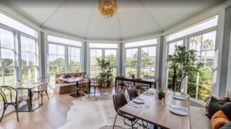 The Conservatory dining room at The Hunting Lodge, Waimauku. Photo / Supplied